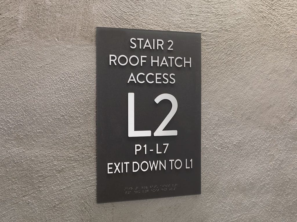 Sign on a wall: "Stair 2, Roof Hatch Access, L2, P1-L7, Exit Down to L1.