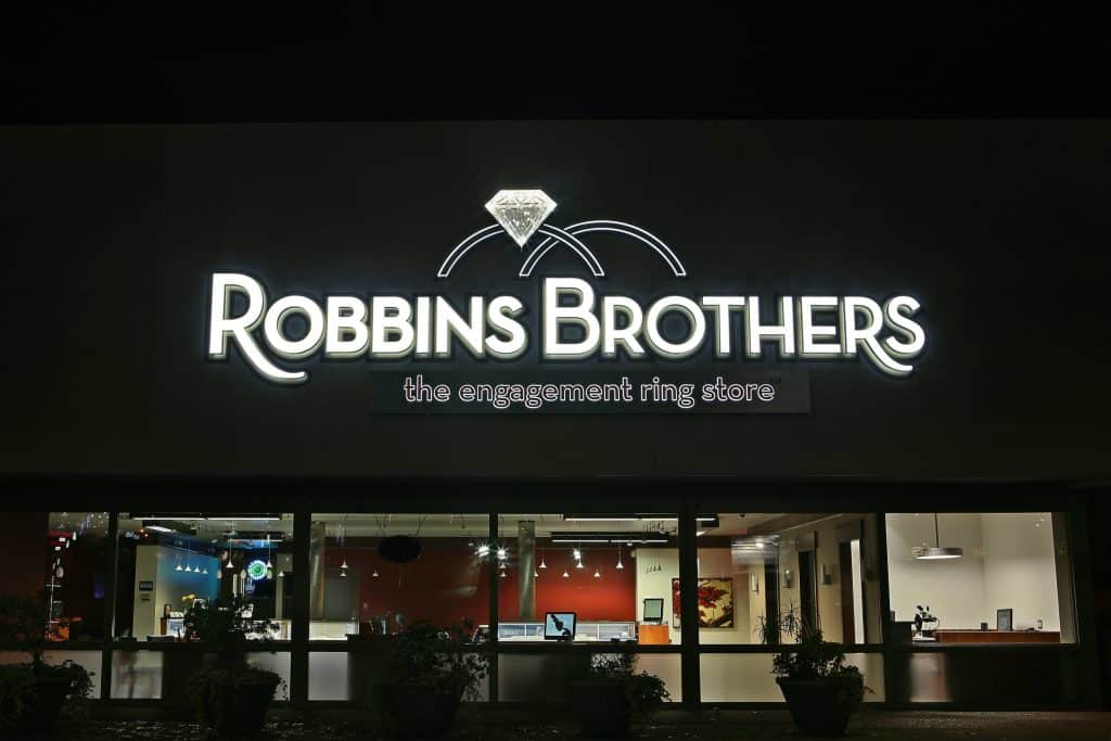 Storefront of Robbins Brothers, an engagement ring store, with illuminated signage and visible interior through glass windows. Storefront of Robbins Brothers, an engagement ring store, with illuminated signage and visible interior through glass windows.