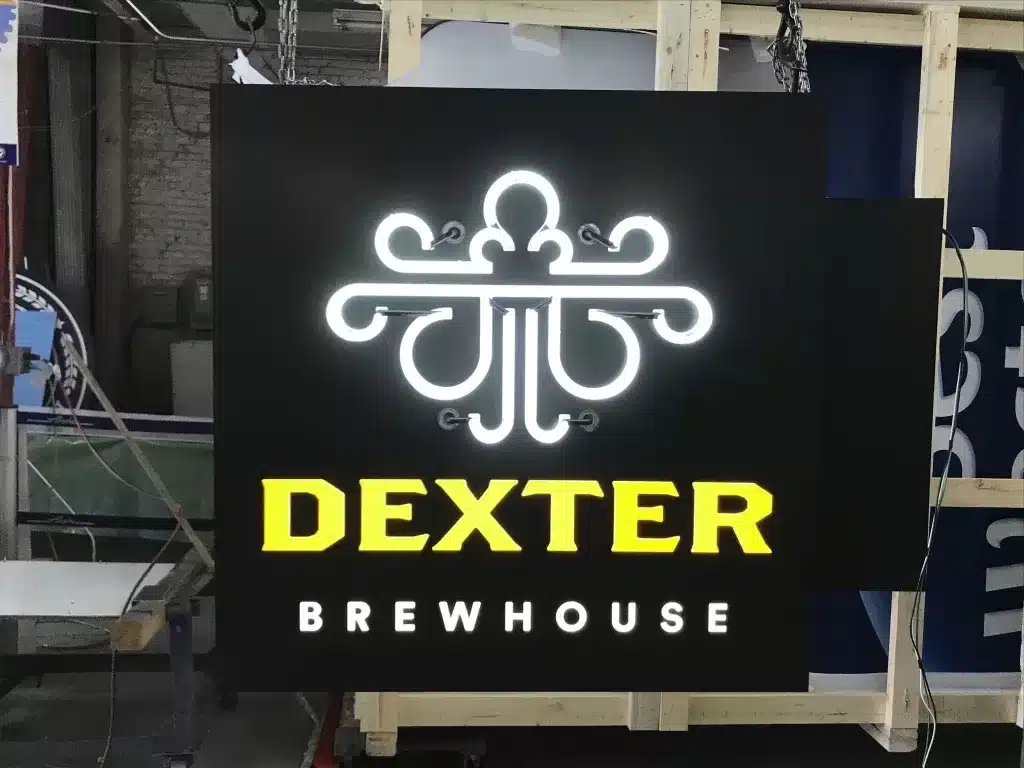 Sign for "Dexter Brewhouse" with a decorative, illuminated design above the text.